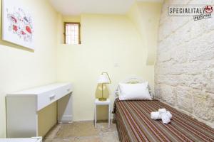 a bedroom with a bed and a stone wall at Mary's Guest House in Bethlehem +7 photos