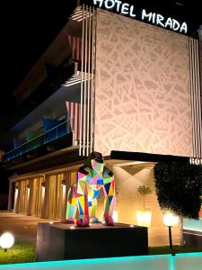 a colorful sculpture in front of a building at Mirada Hotel in Athens