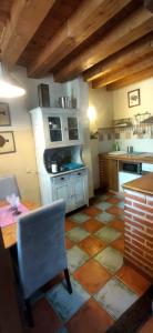 a kitchen with a table and a chair in a room at El Balconcillo-Los Sitios de Aravalle in Umbrías