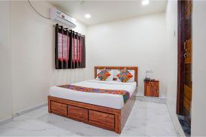 a bedroom with a bed in a room at Via Chaitanya Inn in Pune