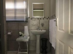 a bathroom with a sink and a mirror at The Studio in Colchester