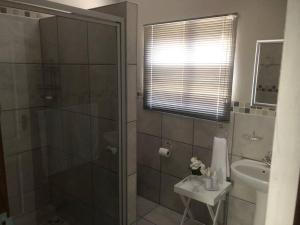 a bathroom with a shower and a sink at The Studio in Colchester