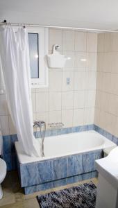 a bathroom with a tub and a toilet and a sink at ΗΒΗ MINI HOME in Chalkida