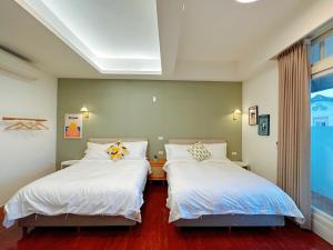 Postel nebo postele na pokoji v ubytování 游遊民宿 Yulazy inn 寵物友善 I 包棟