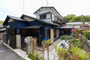 a blue house with a balcony on top of it at EK House Kamakura 鎌倉 Free Parking in Kamakura