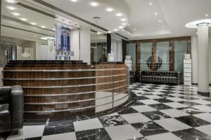 a lobby of a hotel with a checkerboard floor at Hotel Larios Málaga in Málaga