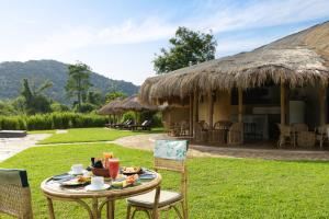 a table with food on it in front of a house at Wild Glamping Gal Oya - Thema Collection in Galgamuwa