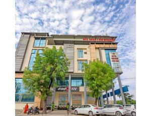 a building with cars parked in front of it at Hotel Shivam Fort View, Chittorgarh in Chittaurgarh