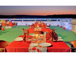 a table with red table cloths and candles on top at Hotel Shivam Fort View, Chittorgarh in Chittaurgarh