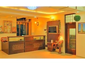 a living room with yellow walls and a table at Hotel Shivam Fort View, Chittorgarh in Chittaurgarh
