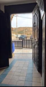 an open door with a view of a parking lot at La colina House taghazout in Taghazout