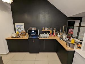 a kitchen with a desk with a laptop on it at Hotel Tempelhof - City-Messe-Arena in Cologne
