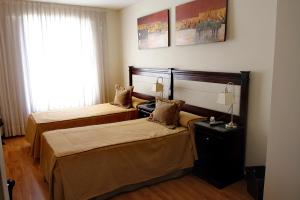 Cama ou camas em um quarto em Villaggio Hotel Boutique