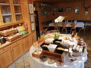 a buffet of food on a table in a restaurant at Gasthof Trausberg in Corvara in Passiria