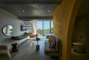 a living room with a couch and a table at Barbados Cherry Villa in Hoi An
