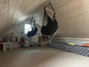 a bedroom with a hammock hanging from a ceiling at Prázdninový dům Za Stodolou in Česká Ves