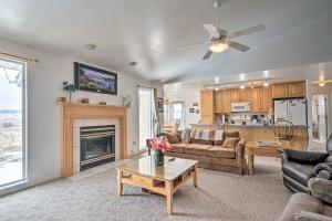 a living room with a couch and a fireplace at Outdoorsy Utah Paradise with Mountain Views! in Salina