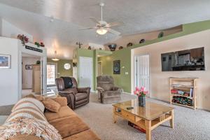 a living room with a couch and a table at Outdoorsy Utah Paradise with Mountain Views! in Salina