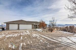 a house with a garage on a gravel driveway at Outdoorsy Utah Paradise with Mountain Views! in Salina