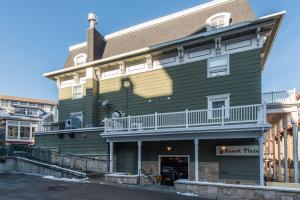 a large green building with a balcony on it at Resort Plaza Condominiums 5002-5025 in Park City