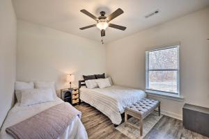 a bedroom with two beds and a ceiling fan at Newly Built Bella Vista Home Near Lakes in Bella Vista
