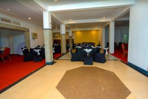 a banquet hall with tables and chairs in a room at Water Front Hotel Kandy in Kandy