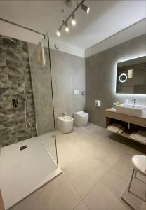 a bathroom with a shower and a toilet and a sink at Hotel Petrarca in Boara Pisani