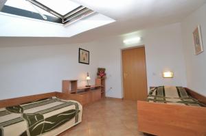 Postel nebo postele na pokoji v ubytování Apartments Ljiljana