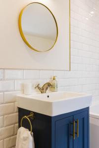 a bathroom with a sink and a mirror at May Tree Cottage Manorbier 5 mins from the beach Sleeps 4 in Manorbier