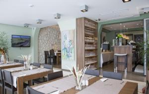 a dining room with tables and chairs at Villa Dalmatina - Adults Only in Bol