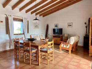 a kitchen and dining room with a table and chairs at Ses Oliveres in Cala Saona