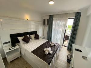 a bedroom with a large bed with towels on it at ATAŞ AQUA OTEL AVŞA in Samanlı +7 photos