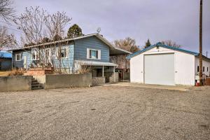 a blue house with a white garage at Billings Apartment with Fireplace and Smart TV in Billings
