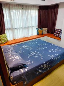 a bedroom with a bed with a blue comforter at The Levels 2BR Condo Fully Interior Cosmo Living in Manila