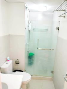 a bathroom with a shower and a toilet at The Levels 2BR Condo Fully Interior Cosmo Living in Manila
