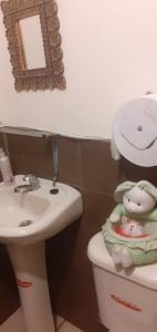 a bathroom with a toilet and a sink and a mirror at Casa N Campestre en las faldas del Taita Imbabura in San Juan de Ilumán +38 photos