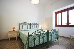 トッレ・スーダにあるVilla Annaのベッドルーム(緑のベッド1台、窓付)