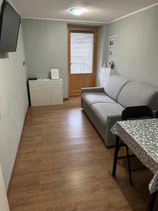 a living room with a couch and a table at Coin de la ville in Villeneuve