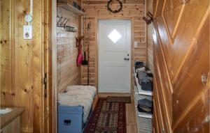 a tiny house hallway with a white door and a stool at Awesome Home In Ustaoset With Wifi in Ustaoset +8 photos
