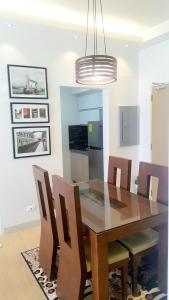 a dining room with a wooden table and chairs at The Levels 2BR Condo Fully Interior Cosmo Living in Manila