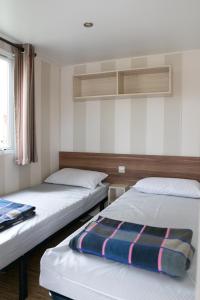 a bedroom with two beds and a window at Camping Tucan - Mobile Homes by Lifestyle Holidays in Lloret de Mar