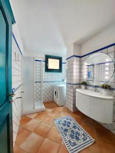 W łazience znajduje się wanna, umywalka i lustro. w obiekcie Jennas-Grecale Apartment w mieście Àrbatax
