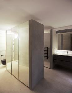 a bathroom with a glass shower and a sink at Valletta Collection - Floriana Maisonette in Il-Furjana