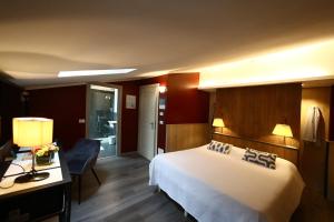 a hotel room with a large bed and a desk at Hotel Italia in Verona