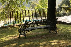 a park bench sitting next to a tree at Can Barrina in Montseny