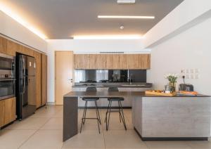 a kitchen with a large island with bar stools at Purple Haze By AirCasa in Nairobi