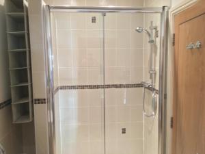 a shower with a glass door in a bathroom at Southover Beach in Woolacombe