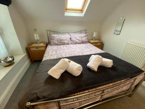 a bedroom with a bed with two pillows on it at Southover Beach in Woolacombe
