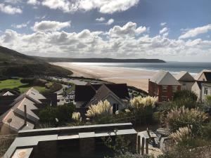 a view of a beach with houses and the ocean at Southover Beach in Woolacombe