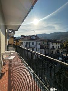a balcony with a table and a view of a city at Fior&Iris Apartments in Stresa